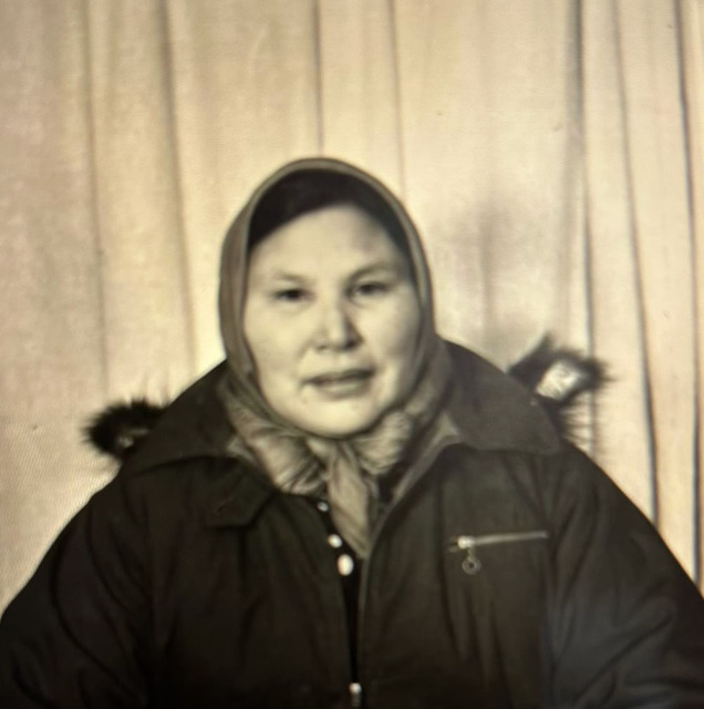 Eliza Blondin seated for a formal portrait, wearing a headscarf and a fur-trimmed winter parka.
